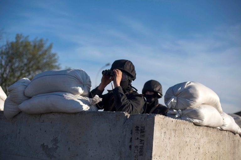 Members of Ukrainian special forces man a check point near Donetsk, Ukraine, Thursday, April 24, 2014.  Ukrainian forces launched an operation Thursday to drive pro-Russia insurgents out of occupied buildings in the country's tumultuous east, prompting new threats from Russian President Vladimir Putin. Within hours of the Ukrainian operation, which killed at least two pro-Russia militants, Russia's defense minister announced new military exercises for troops massed near Ukraine's border. (AP Photo/Manu Brabo)