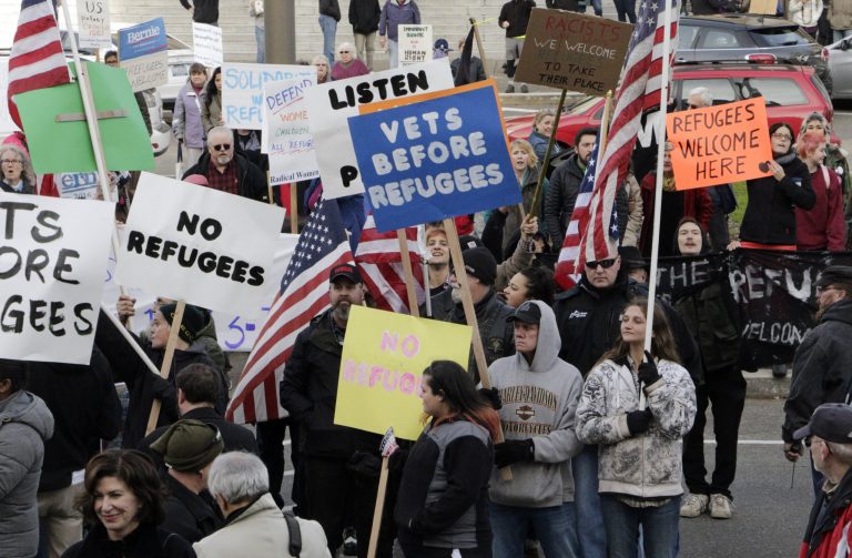 Protesters on opposing sides of the Syrian refugee resettlement issue rally in front of the state Capitol in Olympia, Wash. (AP Photo/Rachel La Corte)