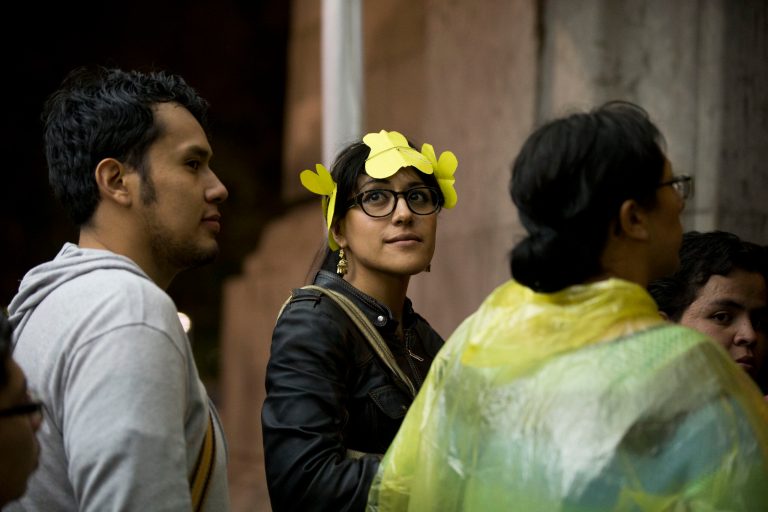 A young woman wears a headband of yellow paper butterflies as she waits to enter an homage for Colombian Nobel Literature laureate Gabriel Garcia Marquez at the Palace of Fine Arts in Mexico City, Monday, April 21, 2014. Garcia Marquez, known throughout Latin American and much of the world simply as 