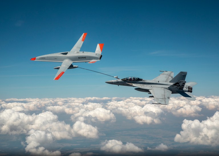 MASCOUTAH, Ill. (June 4, 2021) An unmanned Boeing MQ-25 T1 Stingray test aircraft, left, refuels a manned F/A-18 Super Hornet, June 4, 2021, near MidAmerica Airport in Mascoutah, Illinois.