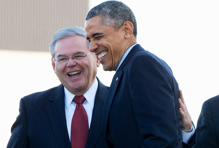President Barack Obama greets Sen. Robert Menendez, D-N.J., upon his arrival aboard Air Force One, Mon day, Dec. 15, 2014, at Joint Base McGuire-Dix-Lakehurst, N.J., where the president will speak to troops. (AP Photo/Jacquelyn Martin)