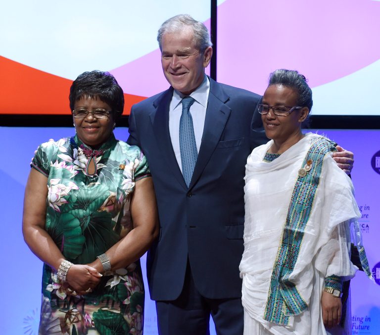 Former President George W. Bush, center, poses for a photo with first lady of Namibia Penehupifo Pohamba, left, and first lady of Ethiopia Roman Tesfaye, right, during the 