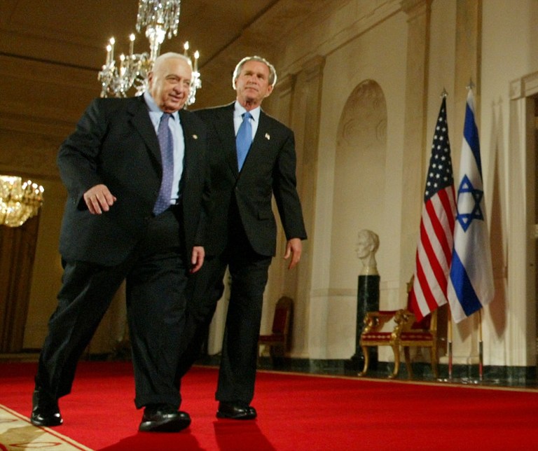 FILE - In this Wednesday, April 14, 2004 file photo, President Bush, right, and Israeli Prime Minister Ariel Sharon, left, walk together at the end of a joint press conference in the Cross Hall of the White House in Washington. The son of former Israeli Prime Minister Ariel Sharon says his father has died on Saturday, Jan. 11, 2014. The 85-year-old Sharon had been in a coma since a debilitating stroke eight years ago. His son Gilad Sharon said: 