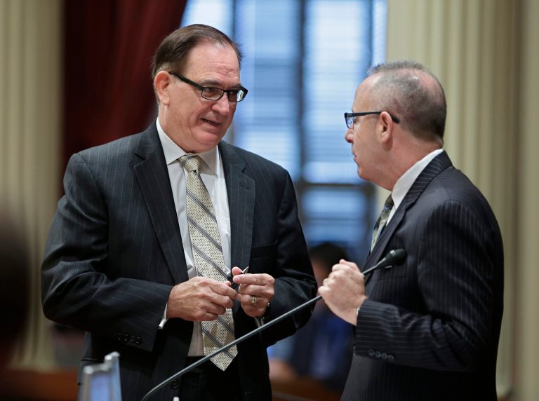 Senate Minority Leader Bob Huff, R-Diamond Bar, left, meets with Senate President Pro Tem Darrell Steinberg, D-Sacramento, during the Senate session, Wednesday, Aug. 13, 2014, in Sacramento, Calif. Lawmakers are scheduled to vote Wednesday on a measure that would swap out an existing water bond on the November ballot and authorize billions in borrowing to pay for new reservoirs, groundwater cleanup and habitat restoration. (AP Photo/Rich Pedroncelli)