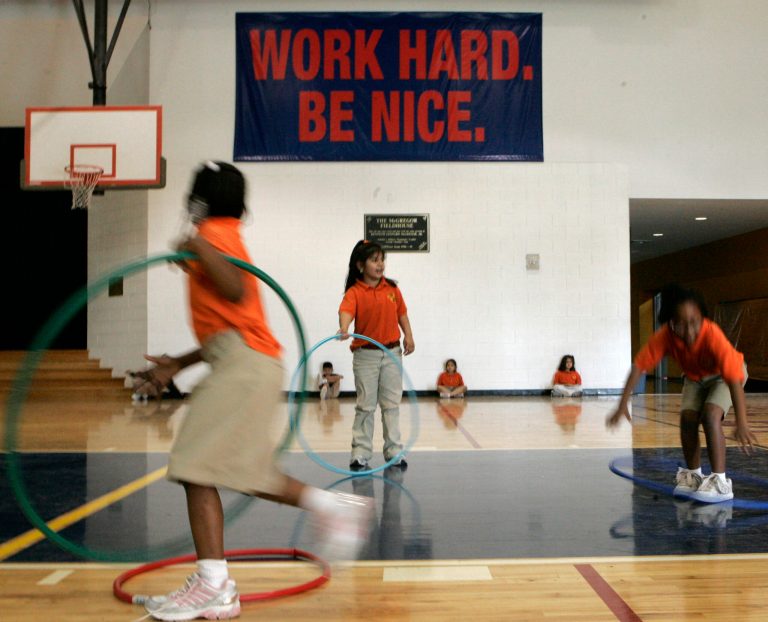 Elementary students play in the school gym below one the many motivational signs hanging in a KIPP charter school Tuesday, April 3, 2007, in Houston. (AP Photo/Pat Sullivan)