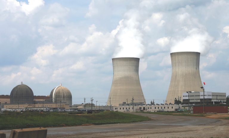 The cooling towers, right, and nuclear reactor containment buildings, left, at a nuclear power plant are shown in Waynesboro, Ga. (AP Photo/John Bazemore)