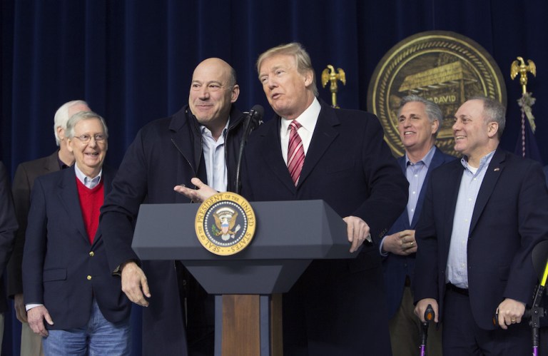 President Trump, center right, speaks as Gary Cohn, director of the U.S. National Economic Council, center left, smiles during a press conference in January. Cohn announced his resignation on Tuesday, triggering a slide in U.S. financial markets. (Chris Kleponis/Pool via Bloomberg)