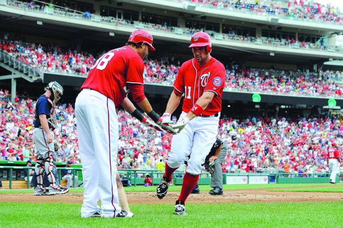 Patrick McDermott/Getty Images
Washington Nationals third baseman Ryan Zimmerman, right, has fought through right shoulder pain this season.