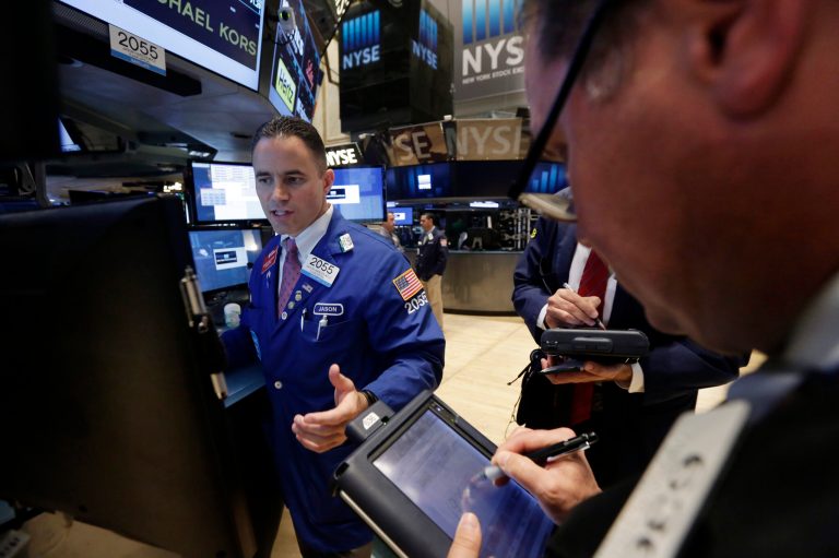 Specialist Jason Hardzewicz, left, works at his post on the floor of the New York Stock Exchange Tuesday, July 8, 2014. U.S. stocks are opening lower for a second day in a row as investors position themselves for corporate earnings reports. (AP Photo/Richard Drew)