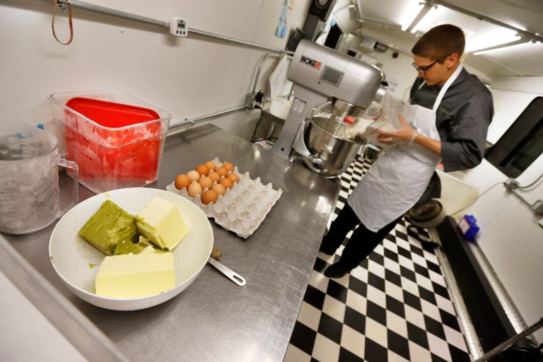 In this June 19, 2014 photo, chef Alex Tretter prepares a batter for peanut butter and jelly cups, with green cannabis-infused 