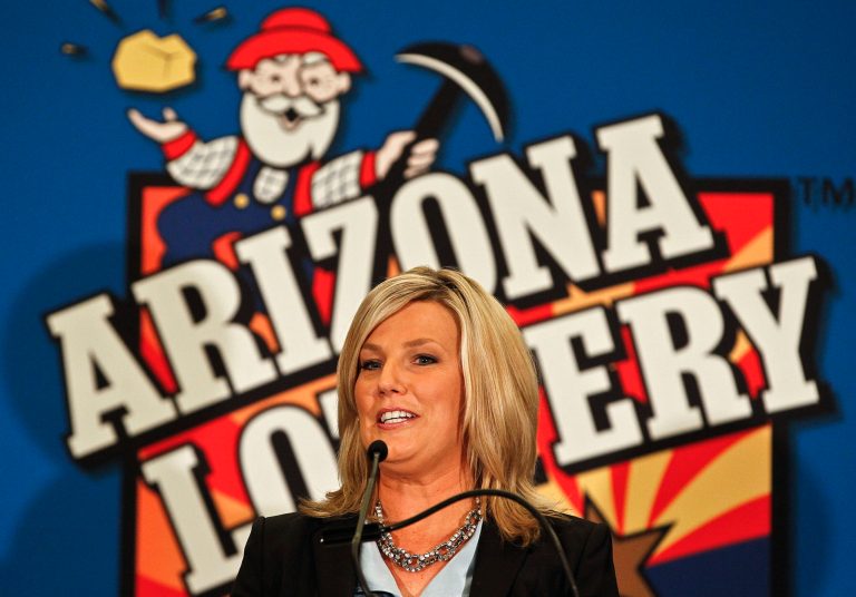   FILE - In this Nov. 29, 2012 photo, Karen Bach, Director of Budget, Products and Communications of the Arizona Lottery, announces during a news conference in Phoenix that one of the winning tickets in the $579.9 million Powerball jackpot was purchased in Fountain Hills, Ariz. The other ticket holders in last week's record $577.5 million Powerball jackpot have claimed their half of the prize but aren't stepping into the spotlight just yet, the Arizona Lottery said Friday, Dec. 7, 2012. (AP Photo/Ross D. Franklin, File)  