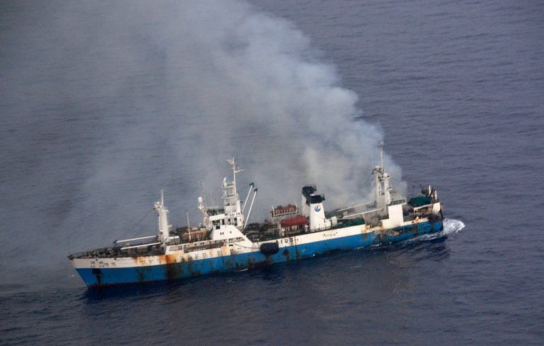 In this picture released by Chile's Air Force, smoke billows from a Chinese factory fishing ship Kai Xin just off the coast of Antarctica, Wednesday, April 17, 2013. Chilean authorities say around 90 crew members have been rescued from the burning ship by the crew of the Norwegian ship Juvel, and Chile's military says it's ready to intervene if necessary to prevent an ecological disaster. (AP Photo/Chile's Air Force)