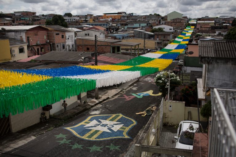 A boy walks on a street decorated for the upcoming World Cup in Manaus, Brazil, Wednesday, May 21, 2014. Manaus is one of the host cities for the 2014 World Cup in Brazil. (AP Photo/Felipe Dana)