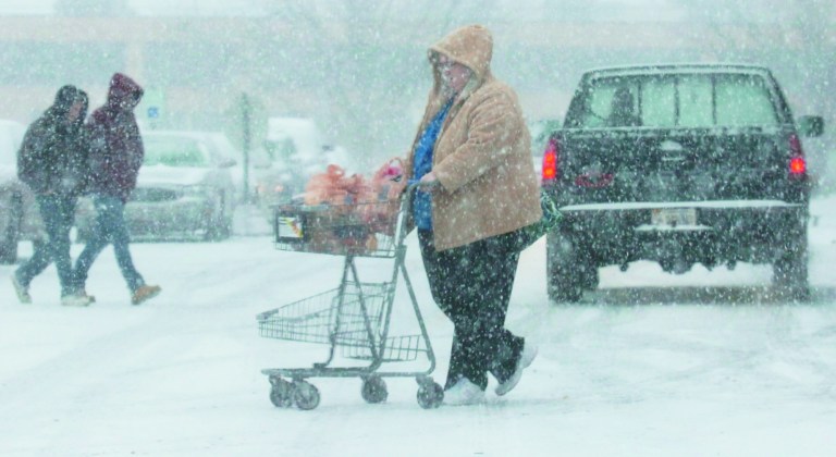 Shoppers buy groceries at the Kroger's in West State Plaza on W. State Blvd during a snow storm in Fort Wayne, Ind., Wednesday, Dec. 26, 2012. (AP Photo/The Journal Gazette, Cathie Rowand)