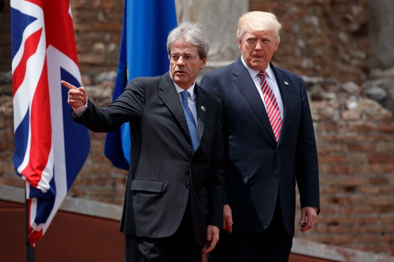 President Trump walks with Italian Prime Minister Paolo Gentiloni after arriving for a photo with G7 leaders Friday in Taormina, Italy. Trump is expected to make his decision on U.S. cooperation with the Paris Climate Accord after his G7 meetings. (AP Photo/Evan Vucci)