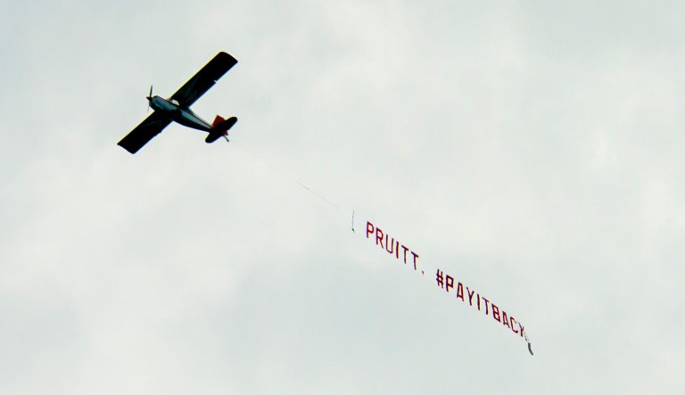 Friends of the Earth flew a single-engine plane over an oil and gas conference as part of a campaign to pressure the EPA chief to pay back $58,000 he spent on private chartered flights. (Annie Mulligan)