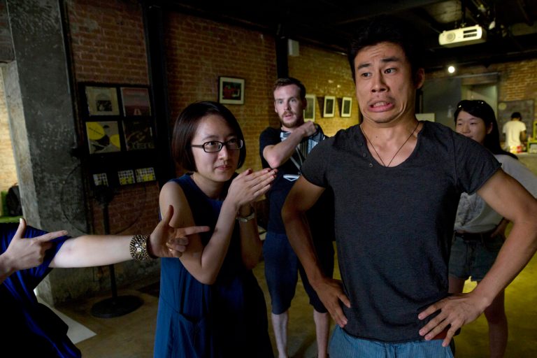 HOLD FOR STORY CHINA LEFTOVER MONOLOGUES BY LOUISE WATT In this photo taken Sunday, July 20, 2014, Wang Anqi, center takes part in a game to warmup before rehearsing for 