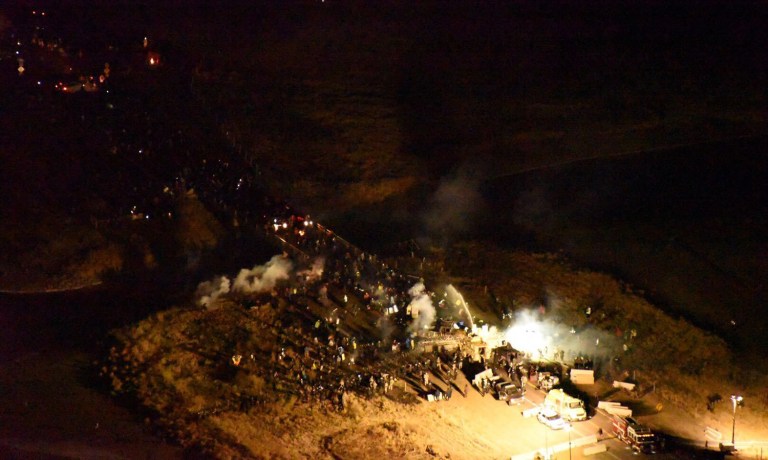 In this image provided by Morton County Sheriff's Department, law enforcement and protesters clash near the site of the Dakota Access pipeline on Sunday, Nov. 20, 2016, in Cannon Ball, N.D. (Morton County Sheriff's Department via AP)