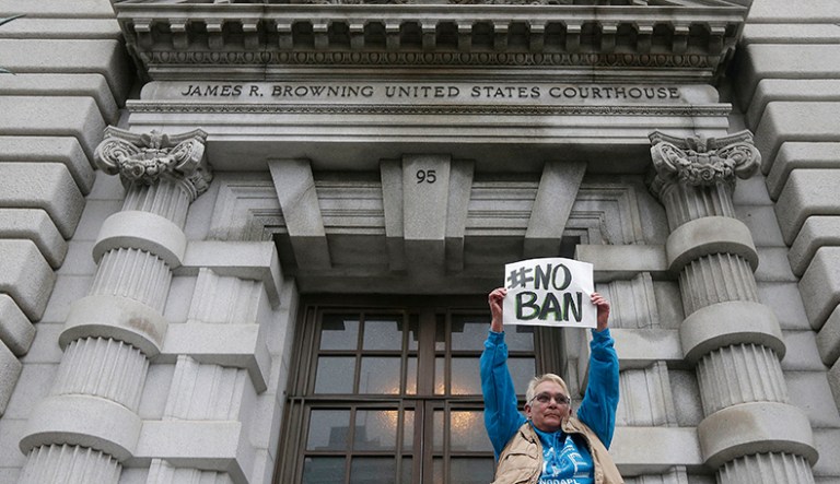 A protester holds up a sign outside of the 9th U.S. Circuit Court of Appeals. President Trump's acknowledgment this week that he has considered breaking up the 9th Circuit Court of Appeals breathed new life into a Republican proposal that has languished in Congress for years. (AP Photo/Jeff Chiu)