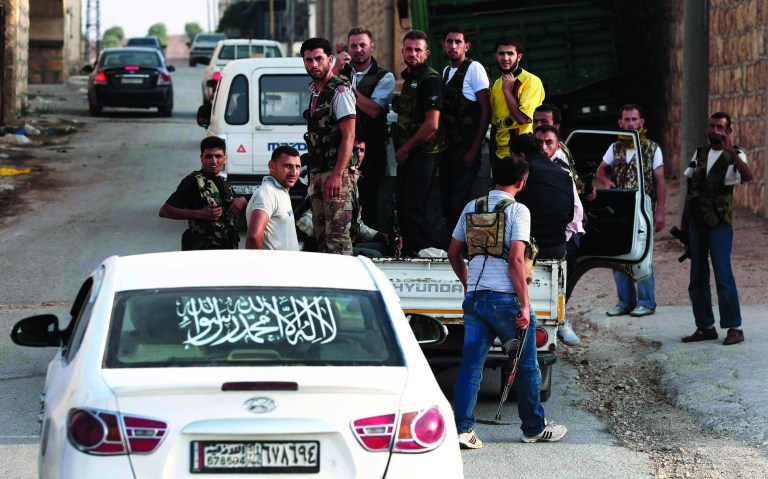 In this Sunday, July 29, 2012 photo, Free Syrian Army soldiers are seen at the border town of Azaz, some 20 miles (32 kilometers) north of Aleppo, Syria. The U.N. said 200,000 Syrians have fled the embattled city of Aleppo since intense clashes between regime forces and rebels began 10 days ago. The government forces turned mortars, tank and helicopter gunships against rebel positions on Monday, July 30, 2012. (AP Photo/Turkpix)
