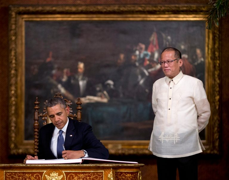 U.S. President Barack Obama signs a guestbook as Philippine President Benigno Aquino III stands by in the Malacanang Palace in Manila, the Philippines, Monday, April 28, 2014. Obama said a 10-year agreement signed Monday to give the U.S. military greater access to Philippine bases will help promote regional security, improve armed forces training and shorten response times to humanitarian crises, including natural disasters. (AP Photo/Carolyn Kaster)