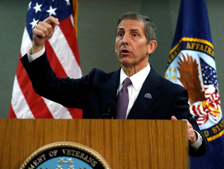 FILE - In this Aug. 6, 2014, file photo, Deputy Veterans Affairs Secretary Sloan Gibson speaks during a news conference during a visit to a Denver veterans hospital. The Veterans Affairs Department is firing four senior executives as officials move to crack down on wrongdoing following a nationwide scandal over long wait times for veterans seeking medical care, and falsified records covering up the delays. Gibson said Monday, Oct. 6, the VA will 