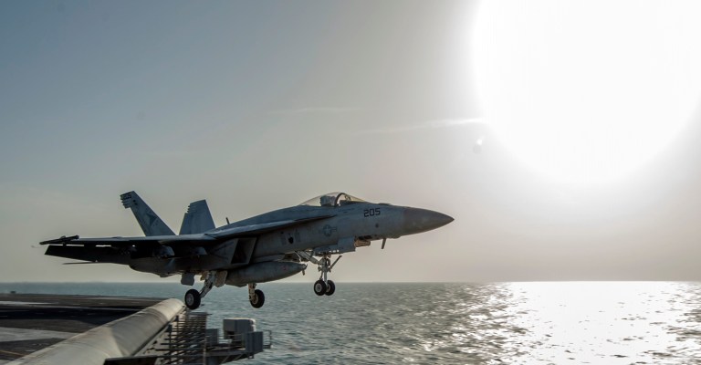 In this image released by the U.S. Navy on Friday, Dec. 5, 2014, a fighter jet launches from the flight deck of the Nimitz-class aircraft carrier USS Carl Vinson (CVN 70) as the ship conducts flight operations in the U.S. 5th Fleet area of operations supporting Operation Inherent Resolve targeting Islamic State militants in Iraq and Syria. (AP Photo/Mass Communication Specialist 2nd Class John Philip Wagner Jr., U.S. Navy)