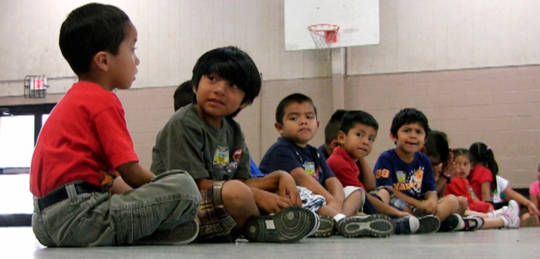 In this Aug. 17, 2011 file photo, students sit in the gym at Crossville Elmentary School in Crossville, Ala. Despite being in an almost all-white town, the school's enrollment is about 65 percent Hispanic. (AP Photo/Jay Reeves, File)