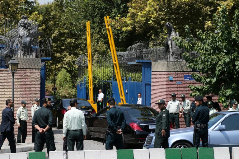 Escorted by Iranian police, a convoy carrying British Foreign Secretary Philip Hammond enters the British Embassy in Tehran, Iran, Sunday, Aug. 23, 2015. (AP Photo/Ebrahim Noroozi)