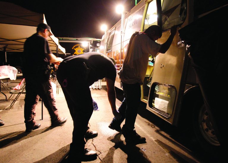 FILE - In this July 29, 2010 file photo, Maricopa County Sheriff's deputies, left, check the shoes of a suspect arrested during a crime suppression sweep in Phoenix. A judge in Arizona on Tuesday, Sept. 18, 2012 ruled that police can immediately start enforcing the most contentious section of the state's immigration law, marking the first time officers can carry out the so-called 