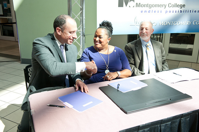 Montgomery County schools superintendent Joshua Starr, Montgomery College President DeRionne Pollard and Dr. Stewart Edelstein, executive director of The Universities at Shady Grove (USG) shake hands after launching the Achieving Collegiate Excellence and Success (ACES) program. (Courtesy photo)
