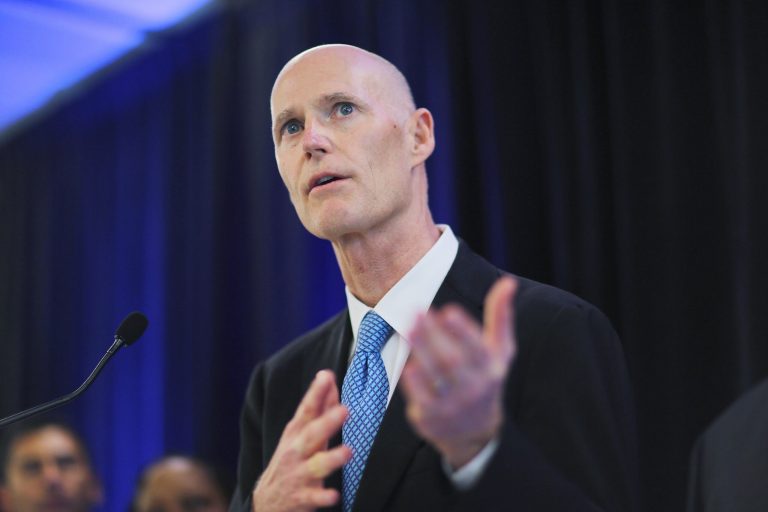 MIAMI, FL - FEBRUARY 22:  Florida Gov. Rick Scott speaks to the media during a visit to the Advanced Pharma to kick-off the grand opening of their new facility that hopes to create 60 new jobs by 2014 on February 21, 2013 in Miami, Florida. Florida Gov. Rick Scott reversed himself on February 20, 2013  and now is callling for an expansion of Medicaid to Florida residents under the federal Affordable Care Act.  (Photo by Joe Raedle/Getty Images)