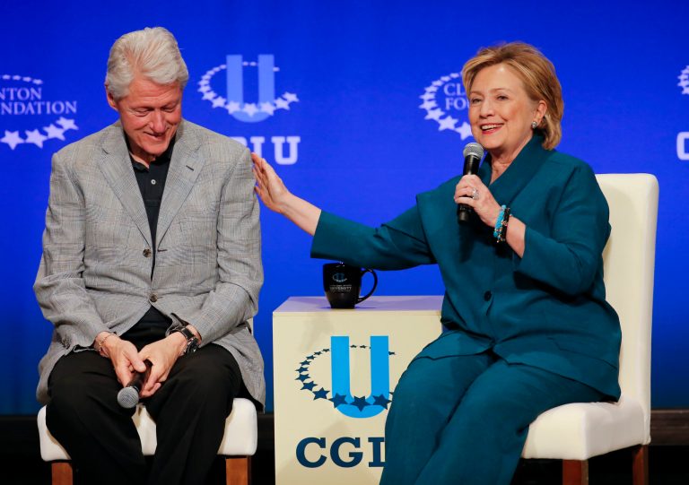 Former President Bill Clinton, left, listens as former Secretary of State Hillary Rodham Clinton speaks during a student conference for the Clinton Global Initiative University at Arizona State University in Tempe, Ariz. (AP/Matt York)