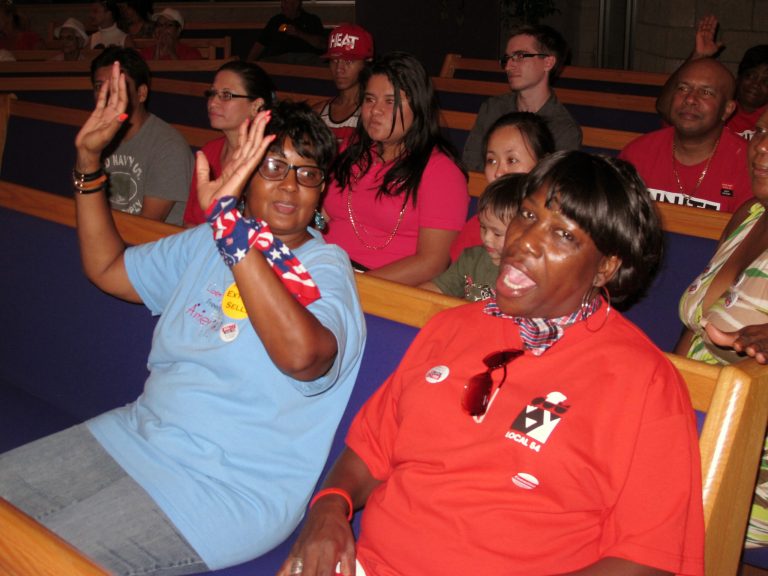 Members of the congregation react to a preacher's sermon during a prayer service Wednesday Aug. 20, 2014 in Atlantic City N.J. for the nearly 8,000 casino workers who will lose their jobs in the next few weeks. Revel, the Showboat and Trump Plaza are all shutting down by mid-September. (AP Photo/Wayne Parry)