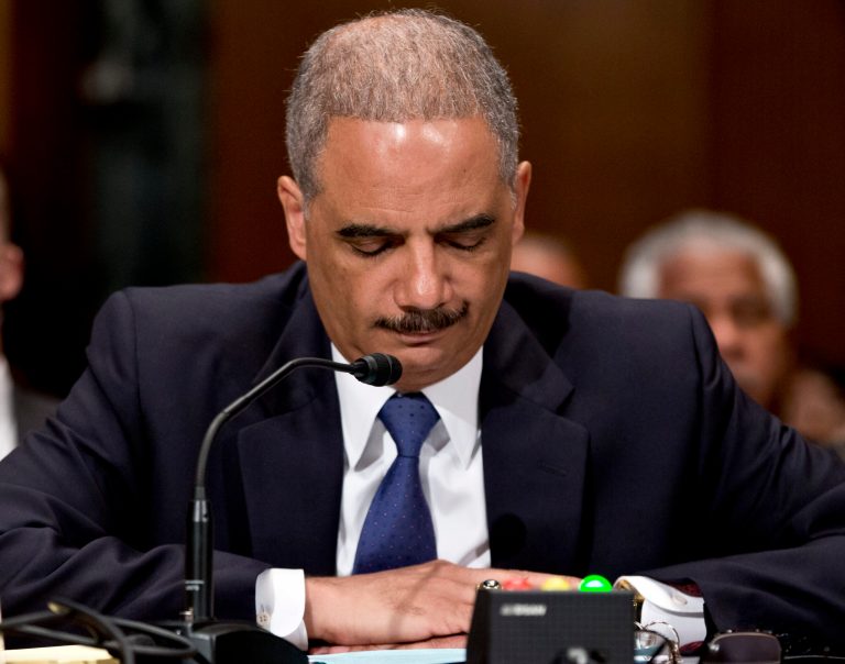 FILE - This June 6, 2013, file photo shows U.S. Attorney General Eric Holder testifying on Capitol Hill in Washington before a Senate Appropriations subcommittee, where Holder denied that the Obama administration is killing suspected terrorists with drone strikes to avoid capturing them and sending them to the Guantanamo prison it wants to close. Holder, who announced Thursday, Sept. 25, 2014, that he would step down once a successor is confirmed, took office determined to turn the page from Bush administration policies that authorized harsh interrogation techniques against suspected terrorists.  (AP Photo/J. Scott Applewhite, File)