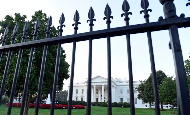 The White House is framed with the fence on the North side of the White House in Washington, Saturday, Sept. 20, 2014. The Secret Service is coming under renewed scrutiny after a man scaled the White House fence and made it all the way through the front door before he was apprehended. (AP Photo/Susan Walsh)