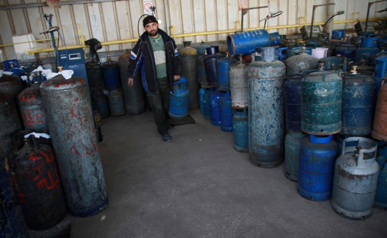 A Palestinian arranges empty cooking gas canisters in Gaza City, Wednesday, March 21, 2012. (AP Photo/Adel Hana)