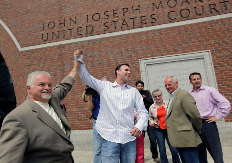   Victims' family members, Steve Davis, left, and Tommy Donahue clasp hands as they react outside federal court in Boston Tuesday, June 12, 2012, after Catherine Greig, who spent 16 years on the run with former Boston mobster James 