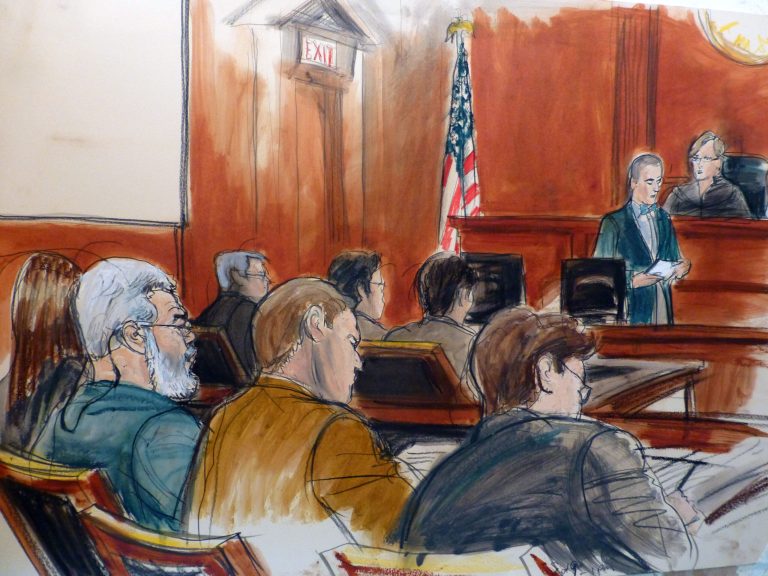 In this courtroom drawing, Egyptian Islamic preacher Mustafa Kamel Mustafa, left, sits in the courtroom of Judge Katherine Forrest, upper right, as Courtroom Deputy Joseph Pecorino reads the jury verdict sheet finding Mustafa guilty in his terrorism trial in New York Monday, May 19, 2014. Referred by prosecutors and defense lawyers alike by his alias, Abu Hamza al-Masri, Mustafa sits next to his defense lawyer Joshua Dratel,  center back, who sits next to defense lawyer Jeremy Schneider, far right. In front of them is the prosecution team. (AP Photo/Elizabeth Williams)