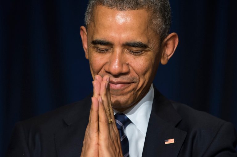 President Barack Obama bows his head towards the Dalai Lama as he was recognized during the National Prayer Breakfast in Washington, Thursday, Feb. 5, 2015. (AP Photo/Evan Vucci)
