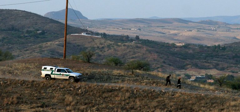 A U.S. Border Patrol agent drives after two suspected undocumented immigrants walking through the hills on May 14, 2006 in Nogales, Arizona. (Photo by Jeff Topping/Getty Images)