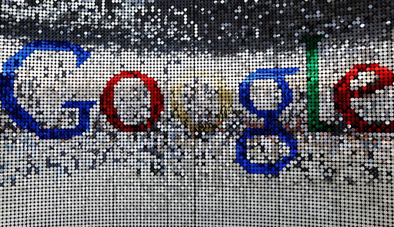 A sign featuring Google's logo stands inside the entrance to their new U.K. headquarters at 6 St. Pancras Square in London on Tuesday, June 21, 2016.
