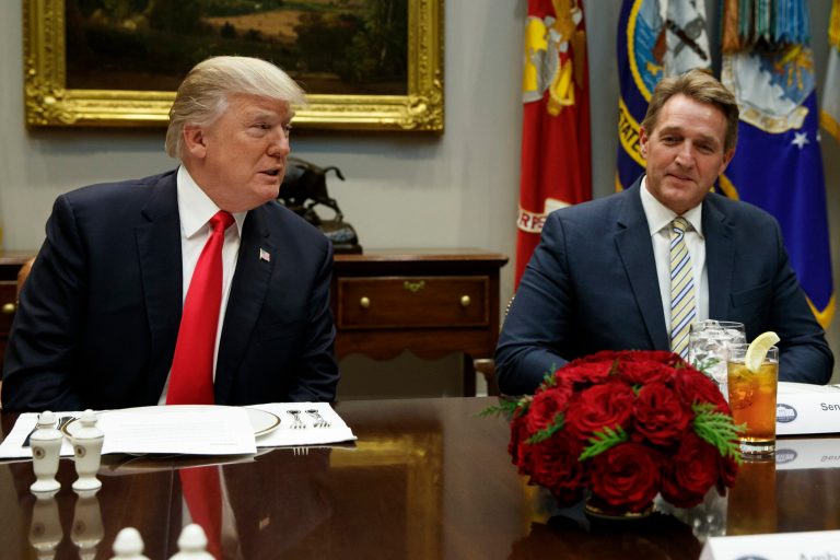 FILE - In this Dec. 5, 2017, file photo, Sen. Jeff Flake, R-Ariz., right, listens as President Donald Trump speaks before hosting a lunch with Senate Republicans in the Roosevelt Room of the White House in Washington. The state's junior senator, Jeff Flake, decided in October not to seek re-election next year as his ongoing battle with President Donald Trump hurt his support in Arizona and he didn't see a path to victory. (AP Photo/Evan Vucci, File)