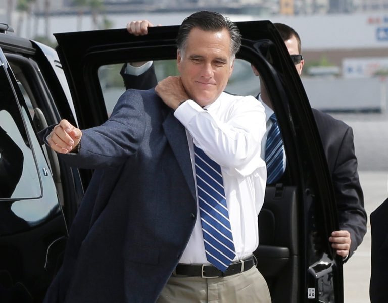 Republican presidential candidate and former Massachusetts Gov. Mitt Romney puts on his jacket before he boards his campaign plane in San Diego, Saturday, Sept. 22, 2012. (AP Photo/Charles Dharapak)