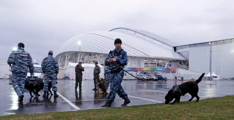 Security personnel walk with their dogs outside Fisht Olympic Stadium at the 2014 Winter Olympics Monday, Jan. 27, 2014, in Sochi, Russia. The Olympics begin Feb. 7th. (AP Photo/David J. Phillip)