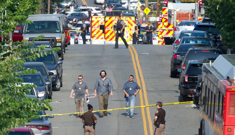 Police and emergency personnel are seen near the scene where House Majority Whip Steve Scalise of La. was shot during a congressional baseball practice in Alexandria, Va. (AP Photo/Cliff Owen)