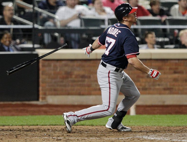 Washington Nationals' Tyler Moore (57) follows through on a two-run home run during the seventh inning of a baseball game against the New York Mets Tuesday, Sept. 11, 2012, in New York. (AP Photo/Frank Franklin II)