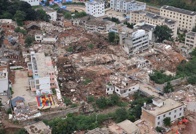 This aerial photo shows buildings toppled down by a 6.5-magnitude earthquake at the quake's epicenter in the town of Longtoushan in Ludian County of Zhaotong, southwest China's Yunnan Province, Monday, Aug. 4, 2014. Rescuers dug through shattered homes Monday looking for survivors of the strong earthquake in southern China as the death toll rose to hundreds of people, with more than 1,800 injured. (AP Photo/Xinhua, Xue Yubin) NO SALES