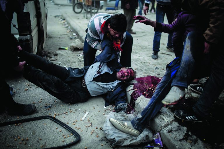 EDS NOTE: GRAPHIC CONTENT - A man helps carry the dead boy of a civilian killed after a mortar attack in the Saif al-Dawlah neighborhood of Aleppo, Syria, Sunday, Jan. 13, 2013. The revolution against the Syrian regime started in March 2011 with peaceful protests but morphed into a civil war that has killed more than 60,000 people, according to a recent United Nations estimate. (AP Photo/Andoni Lubaki)