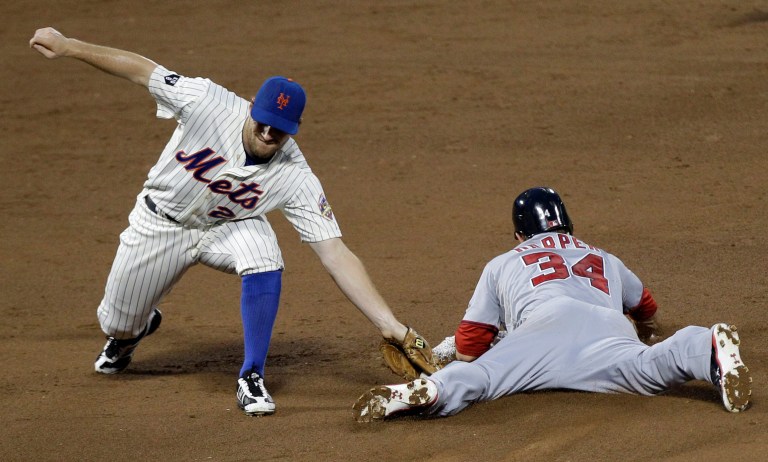 New York Mets second baseman Daniel Murphy misses  the tag on Washington Nationals Bryce Harper (34) who stole second in the third inning of their baseball game at Citi Field in New York, Monday, July 23, 2012. (AP Photo/Kathy Willens)